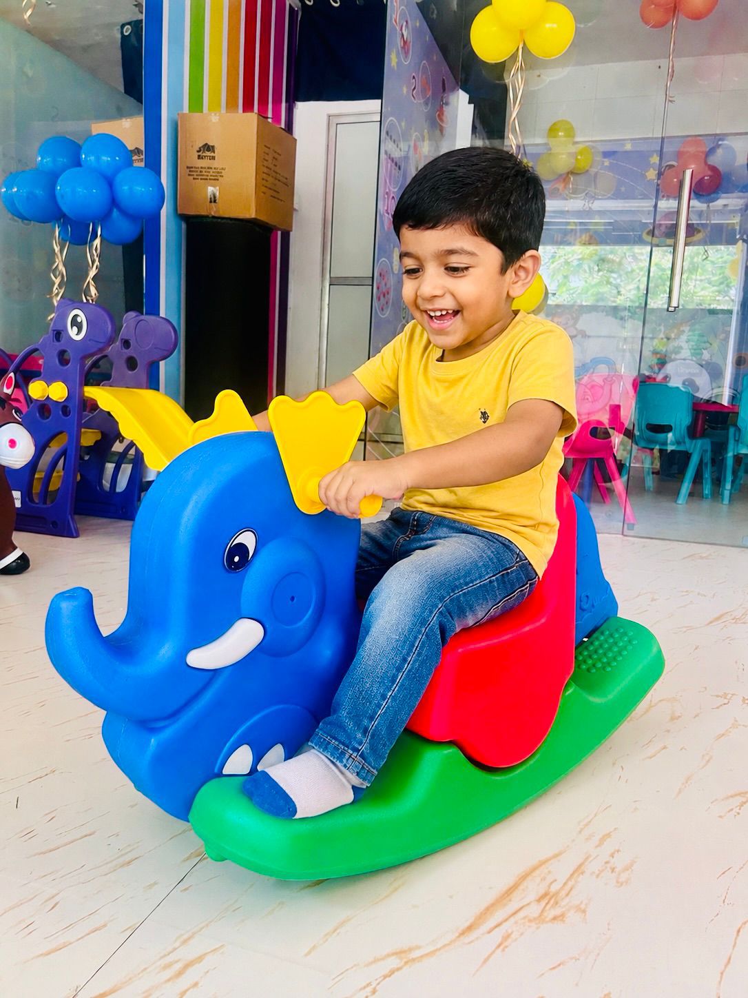 Child enjoying play equipment inside the preschool
